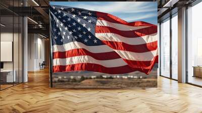 Inspirational image of an American flag waving in the breeze against a clear sky, symbolizing freedom and patriotism, suitable for veteran s day communications or national holiday posters Wall mural