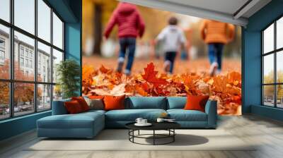 Three children running through a vibrant autumn landscape filled with colorful fallen leaves on a sunny day. Wall mural