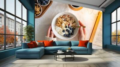 top view book and christmas healthy lifestyle breakfast with granola muesli and yogurt in bowl on wh Wall mural