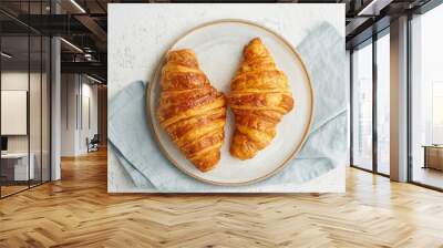 Two delicious croissants on plate and hot drink in mug. Morning French breakfast with fresh pastries. Light gray background. Long width banner Wall mural