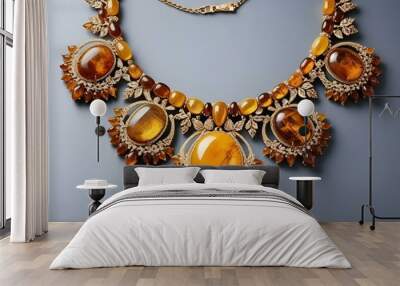 Elegant amber necklace with ornamental design and gemstones on a gray background Wall mural