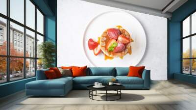 Sweet souffle pancakes decorated with fresh strawberries in a plate Wall mural