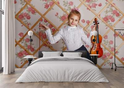 Beautiful gifted little girl playing on violin against the backg Wall mural