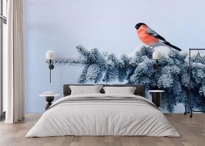 new year postcard bird bullfinch on a branch of a festive spruce with shiny hoarfrost sits in a beautiful winter park Wall mural