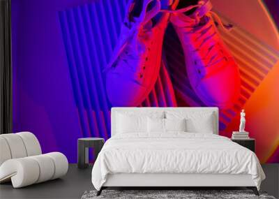 trendy fashion white sneakers on geometry podium on abstract bright background. neon lights on casua Wall mural