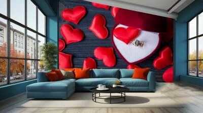 Engagement ring in a red box on a love hearts background. Valentine's day 2019. Wall mural