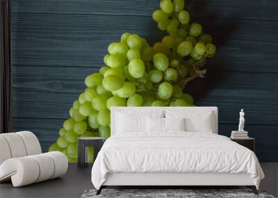 Ripe grapes on a dark blue wooden background. Wall mural