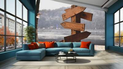 Wooden pointer on the beach. Direction arrows on the beach. Wall mural