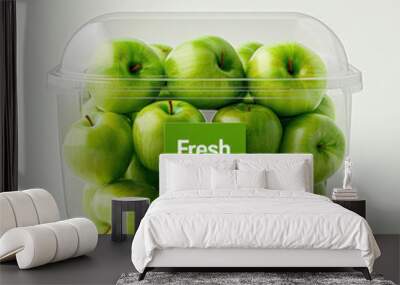 A clear plastic container filled with fresh green apples, labeled 