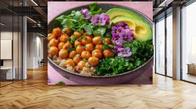 A colorful vegan bowl with quinoa, avocado, chickpeas, and fresh greens, topped with edible flowers, isolated on a pastel pink background, Wall mural