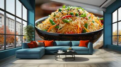 A vegetarian Asian style dinner that includes rice or potato noodles mixed with bell peppers carrots green beans onions sesame seeds and soy sauce creating a delicious and flavorful dish Wall mural