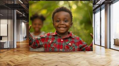 A young boy smiles and waves his hands in the air. AI. Wall mural