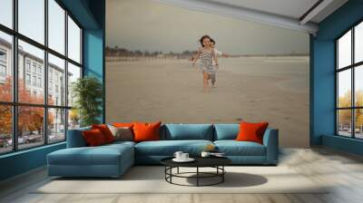 boy running after the girl on the beach Wall mural