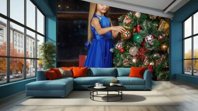 Little blonde girl in blue dress, new year Wall mural