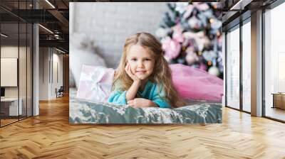 Portrait of little girl near christmas tree Wall mural