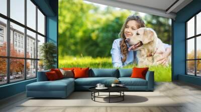 Young woman with golden retriever dog in the summer park Wall mural