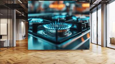 Close-up of a modern stainless steel gas stove with blue flames. The image focuses on the burners ignited with a sharp and vibrant background. Wall mural