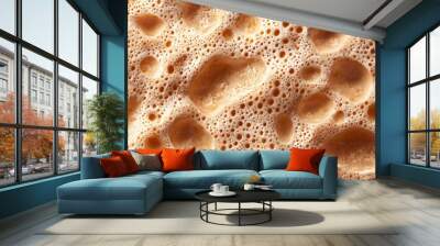 Close-up view of frothy and bubbly surface of creamy liquid with golden brown hues, illustrating texture with varying bubble sizes Wall mural