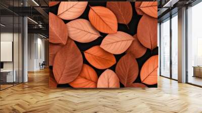 Close-up view of vibrant orange and red autumn leaves scattered under soft sunlight in a tranquil setting Wall mural