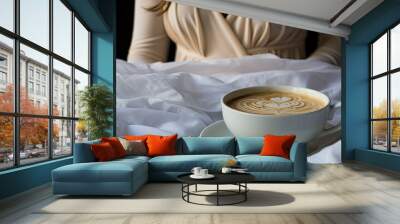 Coffee cup next to feet on bed Wall mural