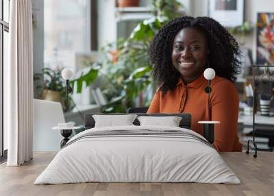 Confident young woman sitting at her desk and smiling at the camera. AI. Wall mural