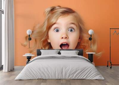 Cute little girl surprised face looking at camera Wall mural