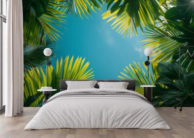 Flat design of tropical palm leaves with a serene blue sky backdrop, Wall mural