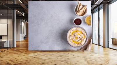 Hummus bowl with olive oil and pita on white background. Wall mural