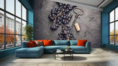 Fresh grape, cork and corkscrew on dark background Wall mural