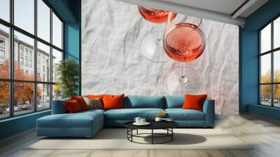 Rose wine in glasses on white linen cloth Wall mural