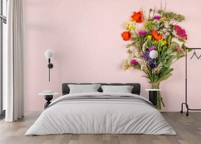 Wild flower bouquet on pastel color background Wall mural