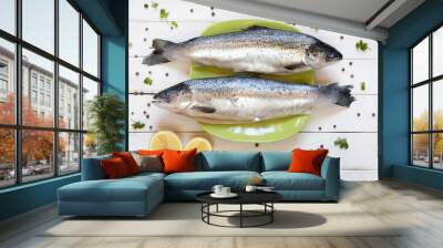 Fresh uncooked salmon on green plate with lemon Wall mural