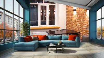 Living room interior in loft style. Sofa and dining table on a brick wall background with lamps Wall mural