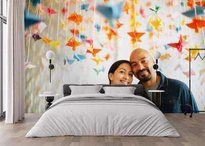 lovebirds in selfie, backdrop of hanging origami swans Wall mural