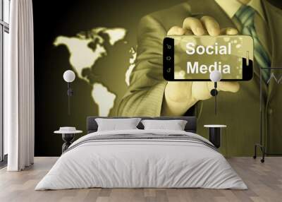 business man hand holding smartphone with Socail Media Wall mural