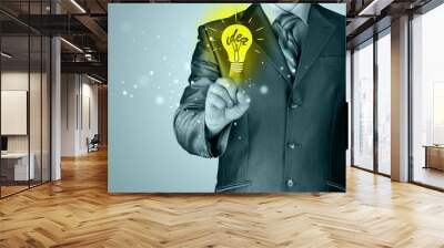 Business man touching light of idea Wall mural