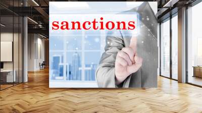 businessman pressing sanctions button on virtual screens Wall mural