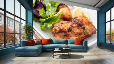 grilled chicken with lemon and salad on white dish Wall mural