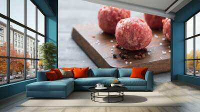 raw meatballs with pepper and salt on wooden board Wall mural