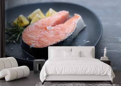 raw salmon with rosemary and lemon on dark plate Wall mural