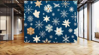 Pattern of various snowflakes in white and light colors on a dark blue background, creating a winter or festive theme. Wall mural