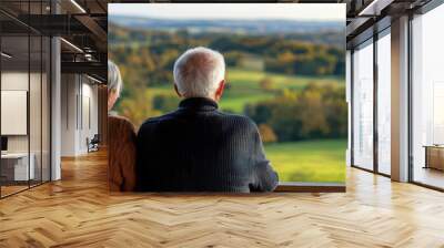 Retired couple looking out over a peaceful countryside from their stable home Wall mural