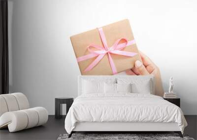 Female hands holding present box or gift box package in craft paper Wall mural