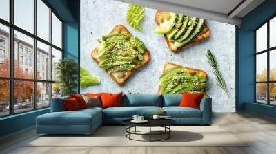 avocado toasts with sesame seeds and pumpkin seeds on the table. Healthy eating concept. Wall mural