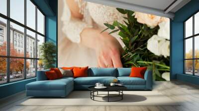 The hands of the bride. The details of the bride. Bride's bouquet. Gentle hands of the bride.   Wall mural