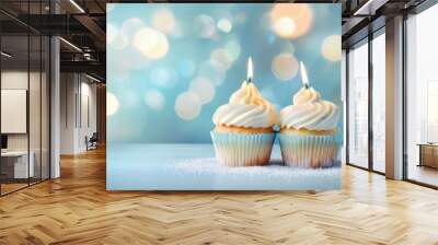 Two cupcakes with candles on top of a table. AI. Wall mural