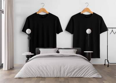 Two plain black t-shirts on wooden hangers against a white background. The shirts are identical in design, featuring short sleeves and a crew neckline. Wall mural