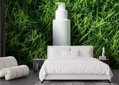 White plastic pump bottle on fresh green grass, natural cosmetic packaging, eco-friendly branding concept Wall mural