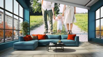 Family on nature. Mother and father with baby outdoors. Wall mural