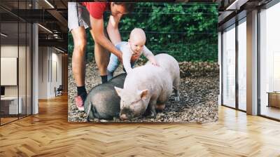 Family with kids in the petting zoo. Wall mural